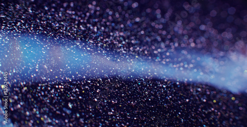 Glitter paint fluid. Volcano dust. Defocused golden sequin glow on dark blue liquid flow background shot on RED Cinema camera.