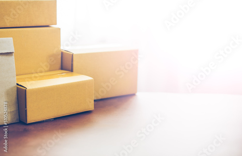 Lot of brown cardboard boxes copy space on table warehouse delivery service shipment goods. cardboard parcel box of product for deliver to customer. Online selling, e-commerce, packing concept.