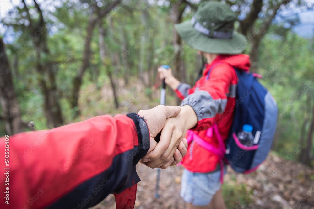 Couple of hikers with backpacks looking over mountains view. Hiking and leisure theme Couple of hikers with backpacks looking over mountains view. Hiking and leisure theme