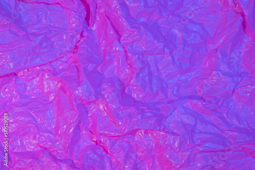 Abstract crumpled paper background in neon light