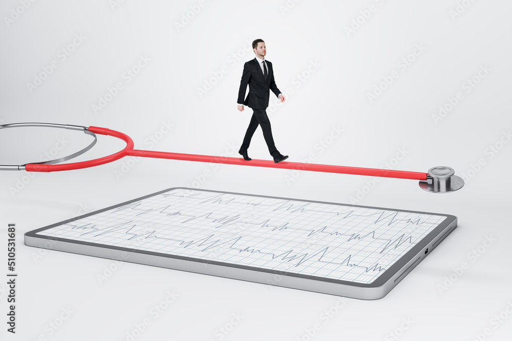 Online medical diagnostic concept with man in black suit walking on red stethoscope above modern digital tablet with cardiogram result on abstract light background Online medical diagnostic concept with man in black suit walking on red stethoscope above modern digital tablet with cardiogram result on abstract light background