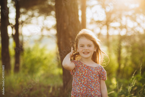 Fototapeta Naklejka Na Ścianę i Meble -  Cute little girl on the meadow in spring day