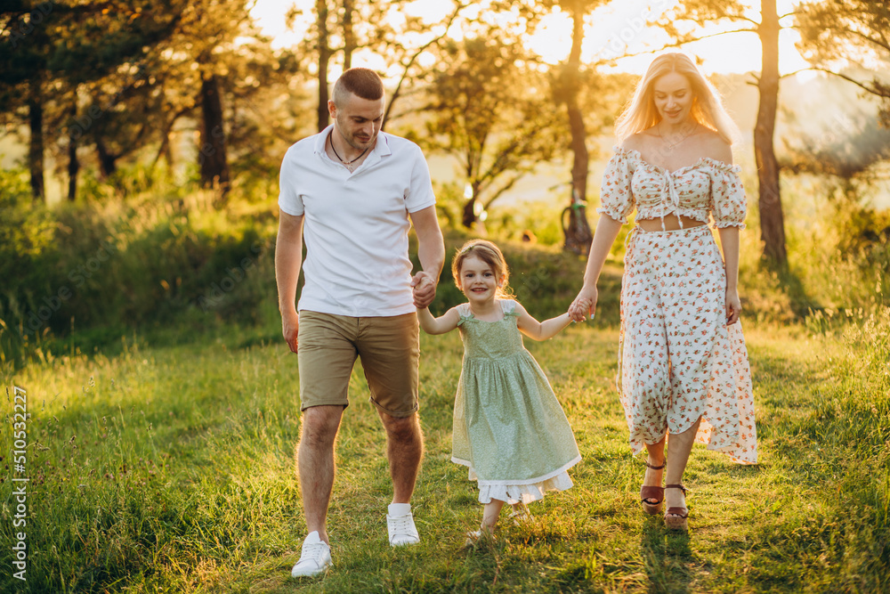Fototapeta premium Happy family resting in summer park.Cheerful family picnicking in the park.Summertime and vacation concept.