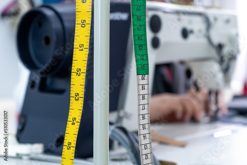 Measuring tape near sewing machine photo