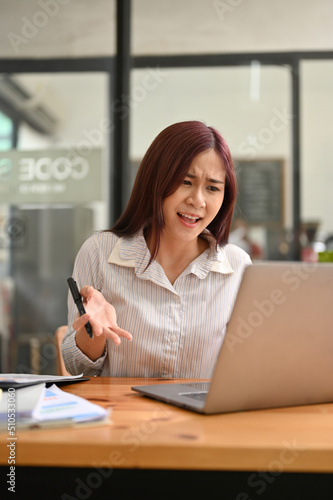 Portrait of an angry unsatisfied asian businesswoman unhappy with her's employee project