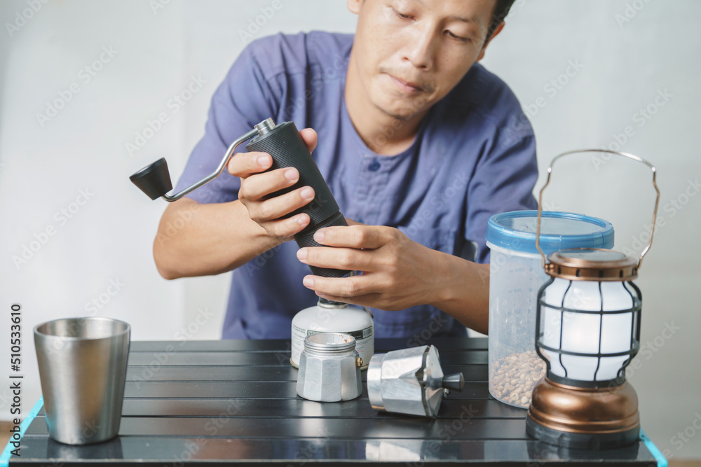 Asian boy learning to make coffee with moka pot. Asian boy learning to make coffee with moka pot.