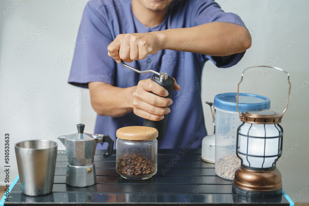 Asian boy learning to make coffee with moka pot. Asian boy learning to make coffee with moka pot.