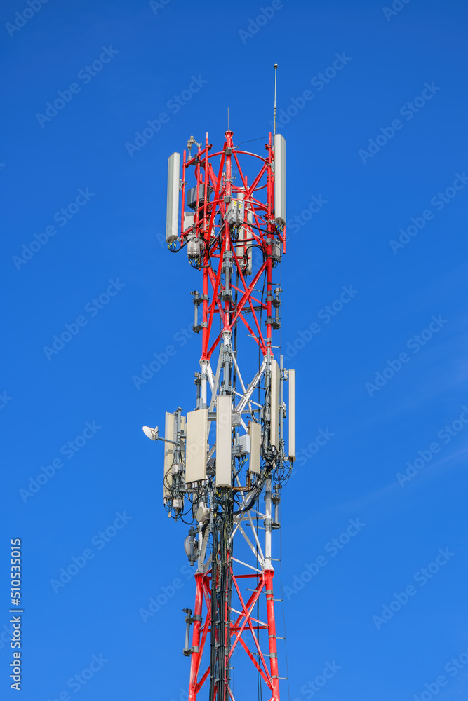 Telecommunication pylon with signal repeaters and antennas against blue sky for wireless technology and broadcasting industry concept Telecommunication pylon with signal repeaters and antennas against blue sky for wireless technology and broadcasting industry concept