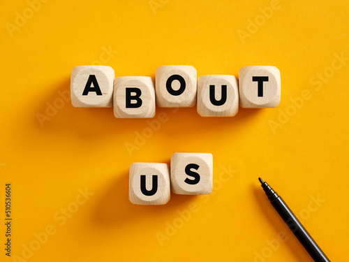 The word about us on wooden cubes. Business communication and information photo