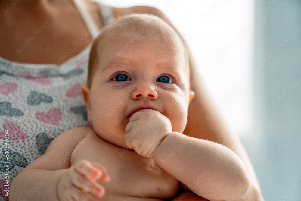 Young tender happy mother hugging her newborn baby smiling Young tender happy mother hugging her newborn baby smiling