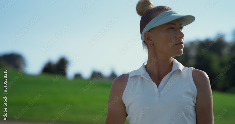 Sexy golf player stretching at course. Beautiful woman doing sport in summer.