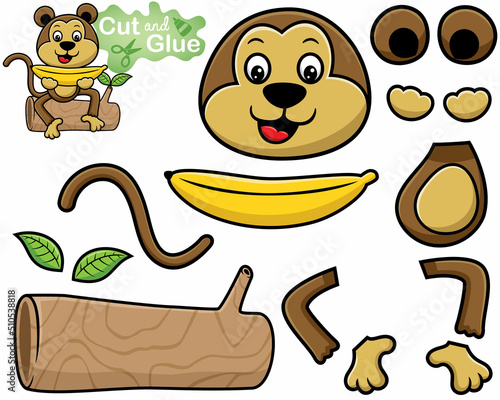 Cartoon of monkey sitting on tree trunk while holding big banana. Cutout and gluing