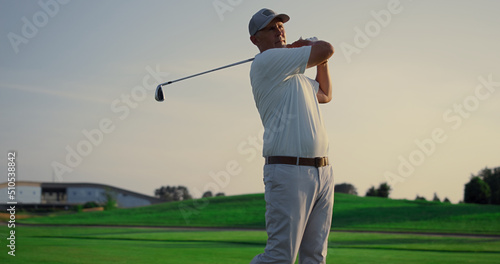 Golf player teeing club putter on sport training. Rich man on luxury vacation.