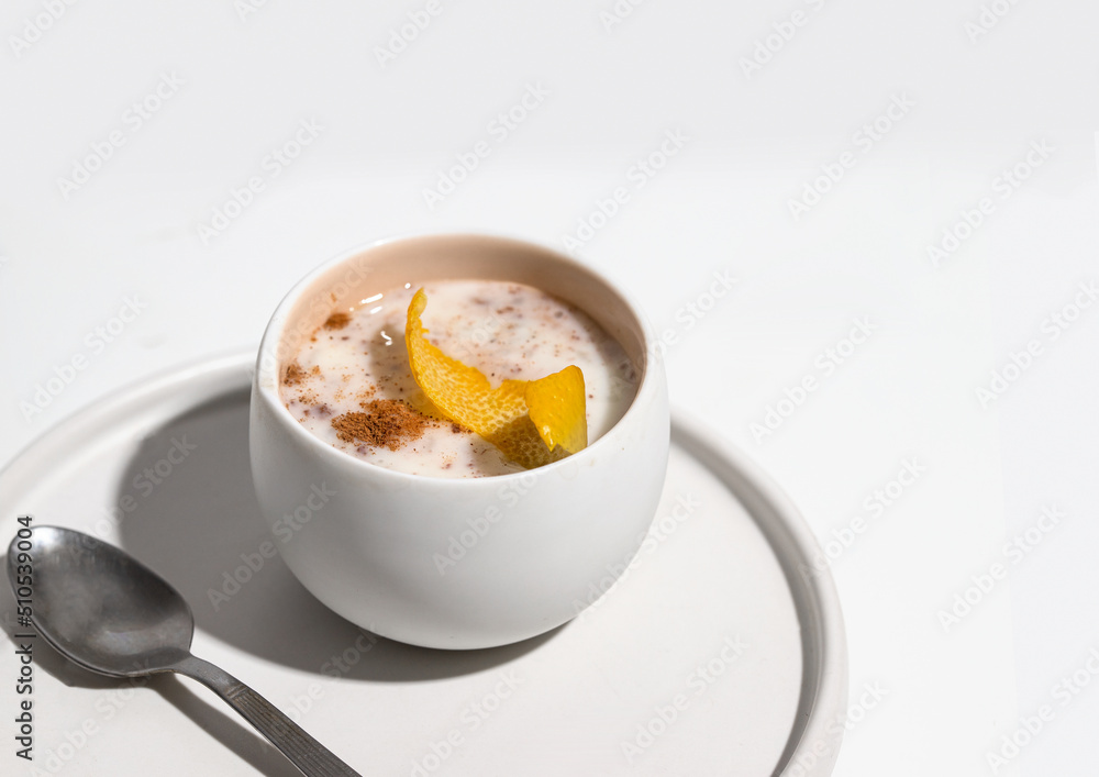 Close up of Creamy rice pudding decorated with lemon slice and cinnamon aon white background. Healthy homemade dessert Close up of Creamy rice pudding decorated with lemon slice and cinnamon aon white background. Healthy homemade dessert