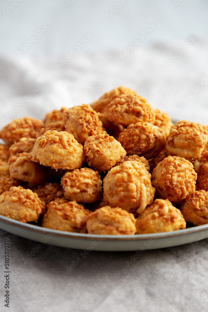 Homemade Crumbly Biscuits with Parmigiano Reggiano on a Plate, low angle view. Close-up. Homemade Crumbly Biscuits with Parmigiano Reggiano on a Plate, low angle view. Close-up.