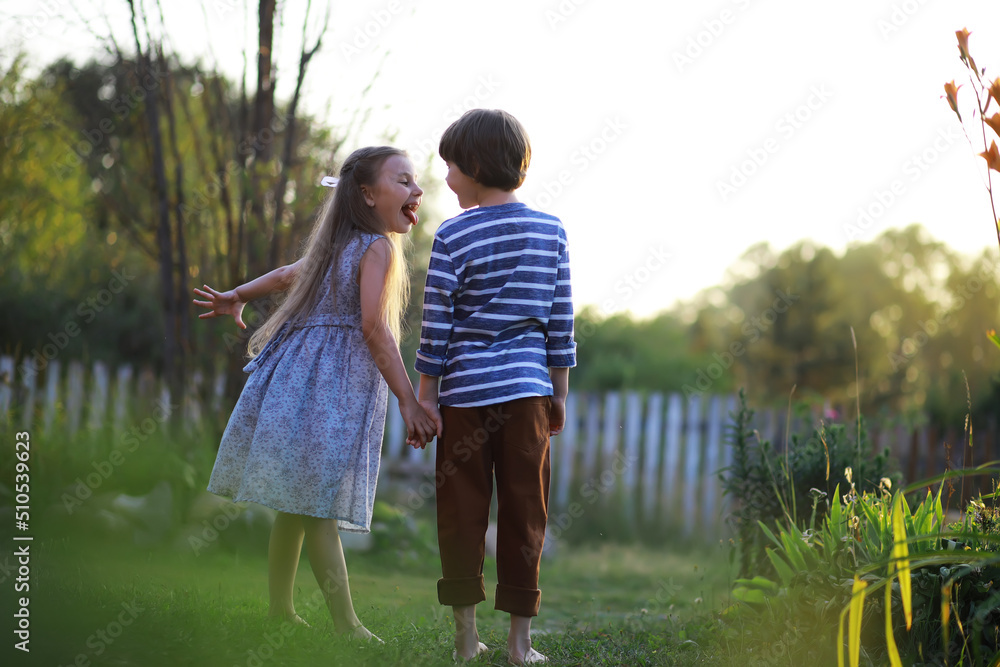 Fototapeta premium Children walk in the summer in nature. Child on a sunny spring morning in the park. Traveling with children.