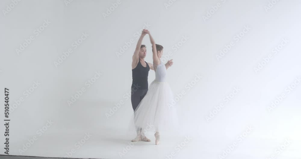 Dramatic couple of classical ballet dancers rehearsing a dance, romantic dance of ballet dancers, a young couple engaged in choreography. Dramatic couple of classical ballet dancers rehearsing a dance, romantic dance of ballet dancers, a young couple engaged in choreography.