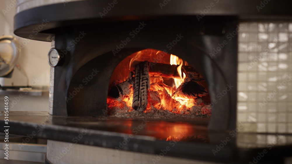 Kitchen stone oven burning fire wood ar italian pizza restaurant. Cook concept.
