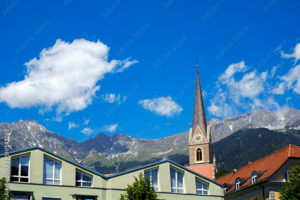 Gothic cathedral tower in Innsbruck Old town in Alps mountains, Tyrol, Austria
