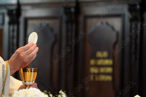 Fotografie Priest showing the host during the mass