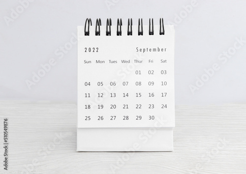 September 2022 desk calendar for planners and reminders on a wooden table on a white background