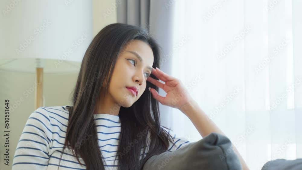 Asian beautiful upset depressed girl sitting alone on bed in bedroom. Asian beautiful upset depressed girl sitting alone on bed in bedroom.