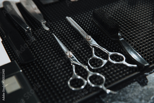 Professional scissors on black background. Hairdressing industry. Professional hairdressing tools