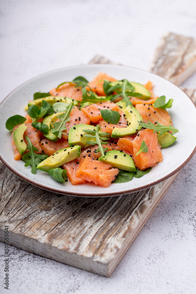 Salmon salad with avocado, for keto and low carb diet. Rusty background, top view, copy space. Salmon salad with avocado, for keto and low carb diet. Rusty background, top view, copy space.
