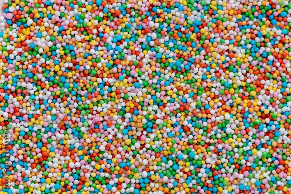 Thousands sprinkles tiny sugar beads for decorating cakes and desserts background. Thousands sprinkles tiny sugar beads for decorating cakes and desserts background.