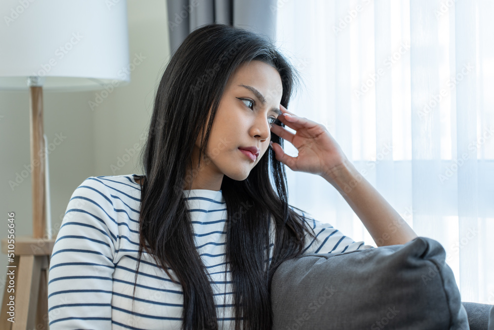 Asian beautiful upset depressed girl sitting alone on bed in bedroom. Asian beautiful upset depressed girl sitting alone on bed in bedroom.