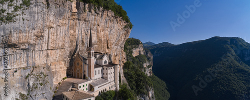 Church in the rock, Santuario della Madonna della Corona. An old church, built around 1625, on a quiet, picturesque mountainside. Madonna della Corona Sanctuary aerial view, surrounded by mountains.