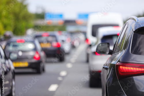 Traffic jam congestion with rows of cars on highway or motorway in rush hour photo