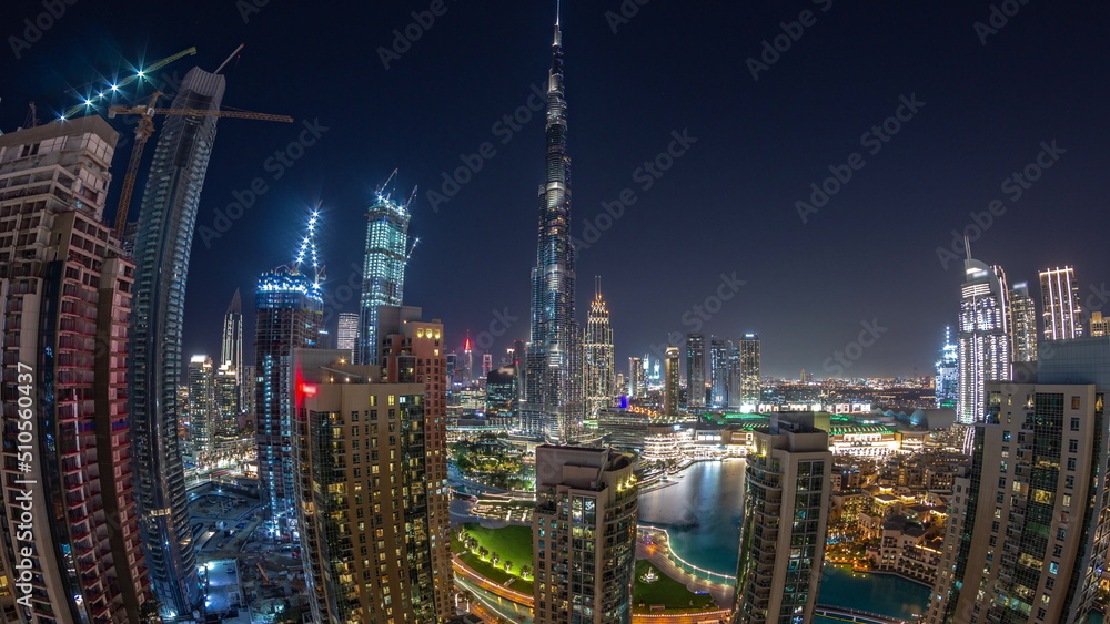 Fototapeta premium Panorama of Dubai Downtown cityscape with tallest skyscrapers around aerial night timelapse.