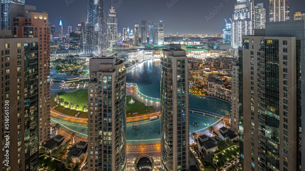 Αυτοκόλλητο Panorama showing Dubai Downtown cityscape with tallest skyscrapers around aerial night timelapse