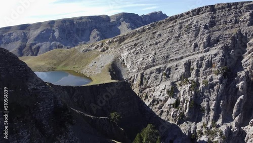 Aerial drone video from iconic and beautiful lake Drakolimni of Tymfi mountain which resides at high altitude above sea, Vikos National Park, Zagori, Greece photo