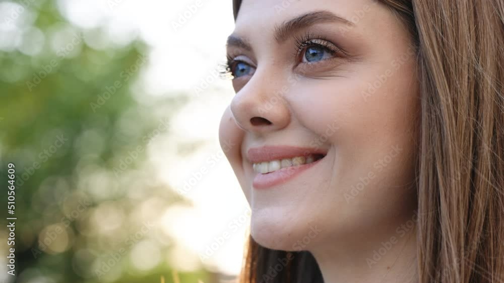 Gorgeous face of young white mixed-race elegant girl with blue eyes. Close-up beautiful caucasian european woman looking stright outdoors. Stand outdoor relax. Happy relax. Female portraits.