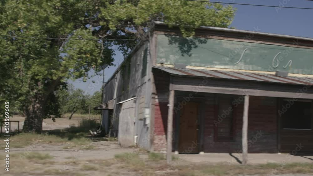 Slow motion driving down rural country road in small town Texas as seen through car window Slow motion driving down rural country road in small town Texas as seen through car window