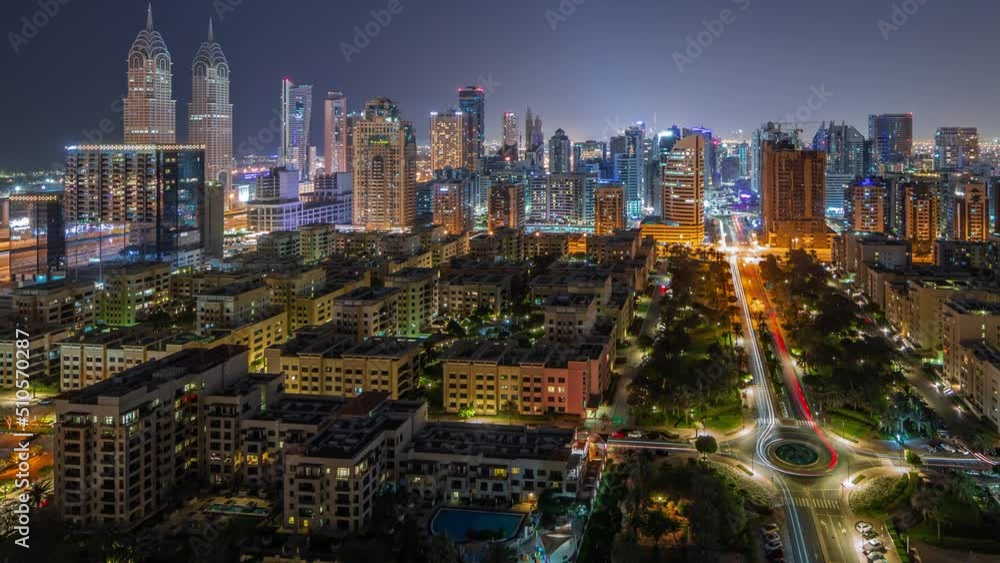 Skyscrapers in Barsha Heights district and low rise buildings in Greens district aerial during all night timelapse. Dubai skyline with lights turning off in internet city towers Skyscrapers in Barsha Heights district and low rise buildings in Greens district aerial during all night timelapse. Dubai skyline with lights turning off in internet city towers