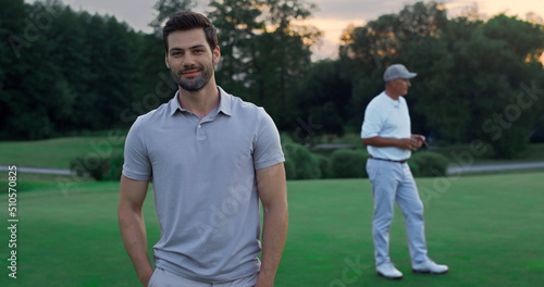 Smiling golfer enjoy play on activity course. Sportsmen team relax at golf club.