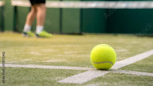 Yellow ball on floor behind paddle net in green court outdoors. Padel tennis © REC Stock Footage