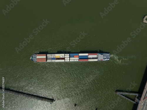 Heavy transport container bulk carrier freighter overhead top down view on sea lake open water isolated. Commercial maritime sea shipping.