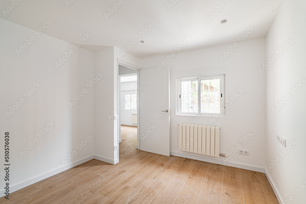 Empty room with window and hardwood floor after renovation. New apartment for rent or sale. Empty room with window and hardwood floor after renovation. New apartment for rent or sale.