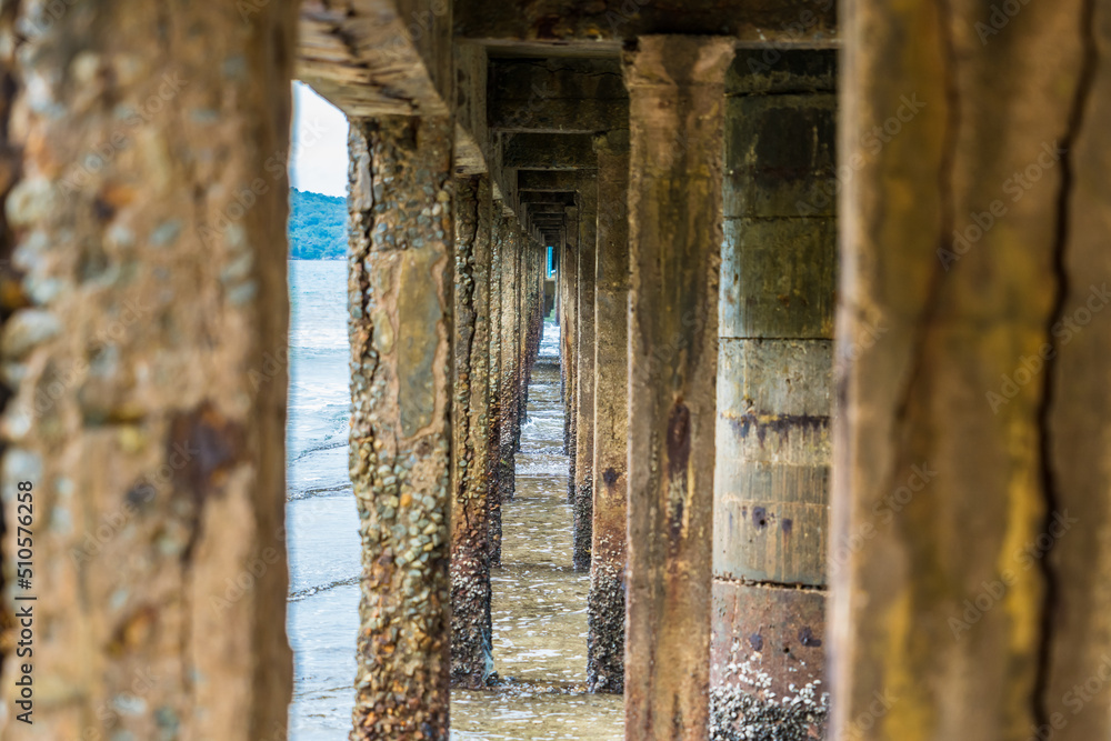 Naklejka premium View Under the bridge walkway at the pier from the beach to the sea.Thailand.
