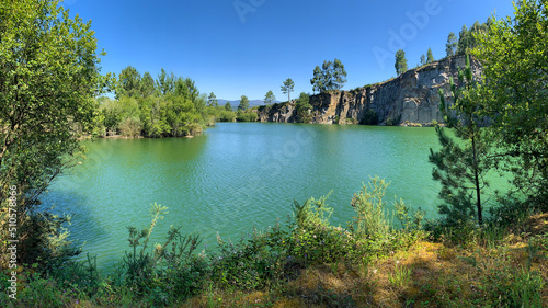 beautiful quarry lake against the blue sky on a sunny day, natural landscape