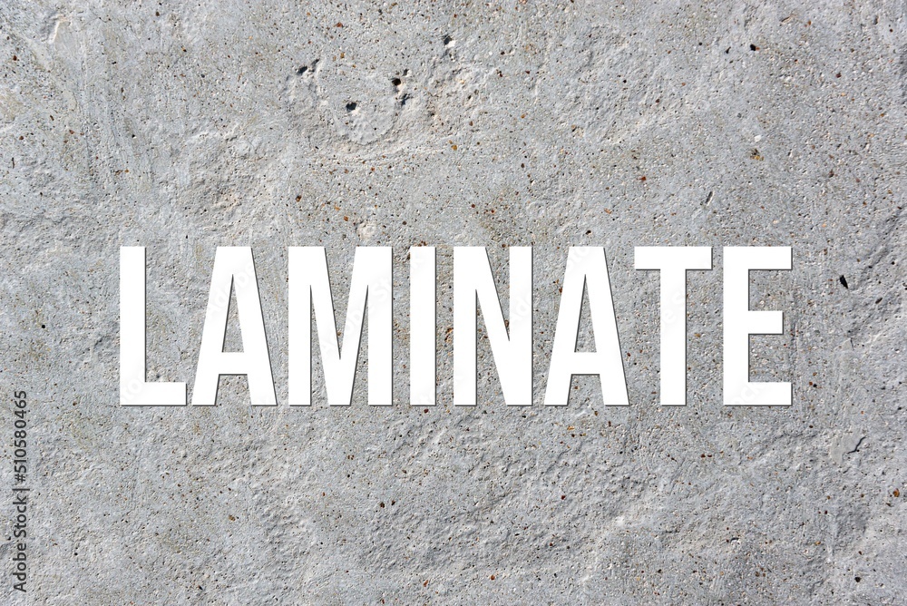LAMINATE - word on concrete background. Cement floor, wall. LAMINATE - word on concrete background. Cement floor, wall.