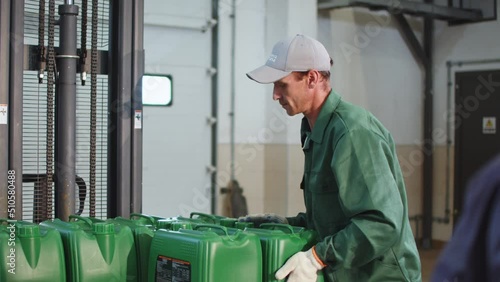 Worker on Production Line Taking the Canister photo