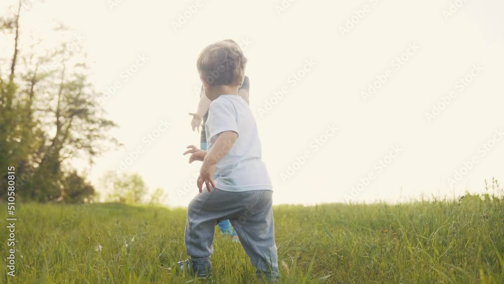 baby run the first steps. kid running in nature on the grass in park silhouette. happy family kid dream concept. people in the park. baby lifestyle run, outdoor fitness forest. happy family catch-up baby run the first steps. kid running in nature on the grass in park silhouette. happy family kid dream concept. people in the park. baby lifestyle run, outdoor fitness forest. happy family catch-up