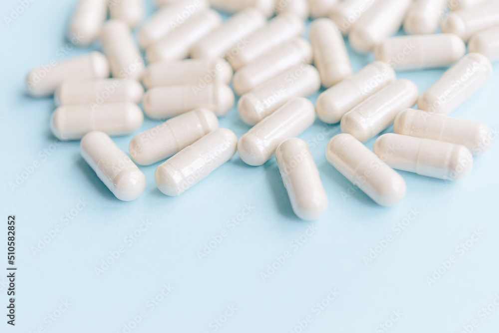 Organic herbal capsules on a blue background. Medical background with copy space for text
Organic herbal capsules on a blue background. Medical background with copy space for text