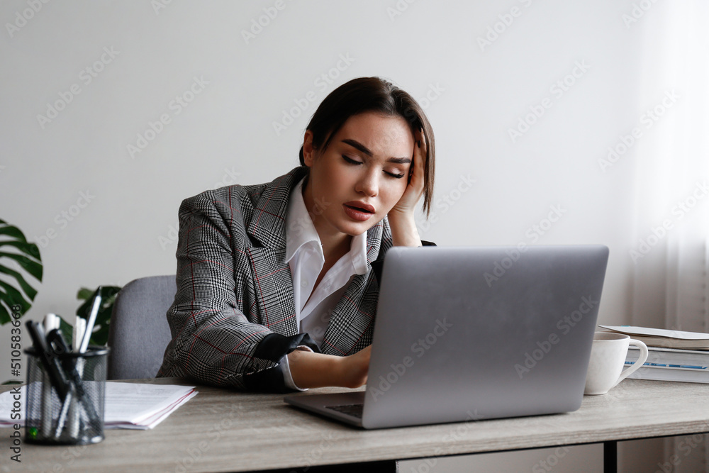 Portrait of a young businesswoman in a state of emotional, physical and mental exhaustion caused by excessive work related stress. Professional burnout concept. Close up, copy space, background. Portrait of a young businesswoman in a state of emotional, physical and mental exhaustion caused by excessive work related stress. Professional burnout concept. Close up, copy space, background.