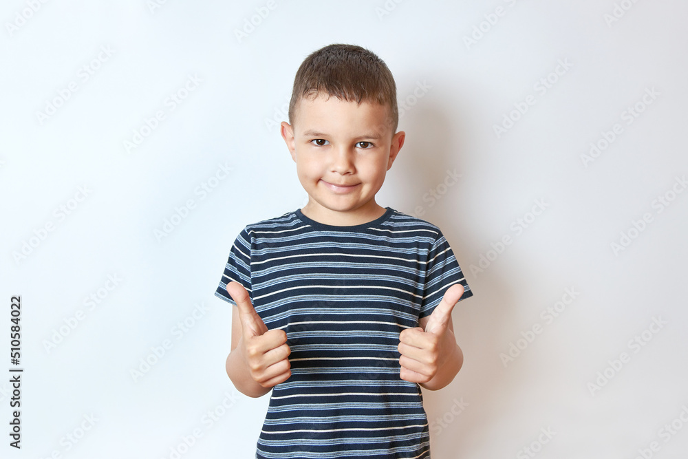 A handsome smiling boy shows his hands to his liking. A handsome smiling boy shows his hands to his liking.